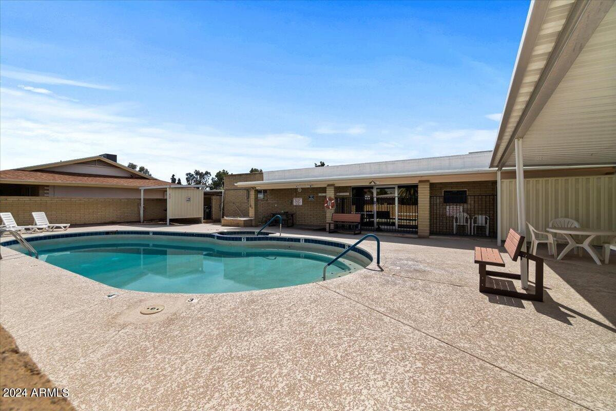 6438 East Butte Street, Unit 2 Mesa, AZ 85205 - Photo 25 of 27 a view of a swimming pool with chairs in patio