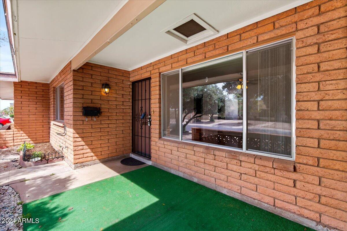 6438 East Butte Street, Unit 2 Mesa, AZ 85205 - Photo 5 of 27 a front view of a house with garden