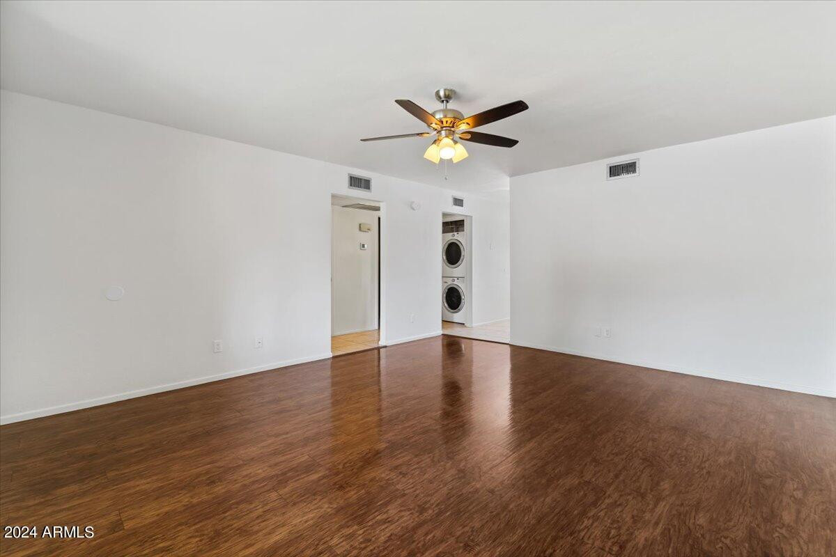 6438 East Butte Street, Unit 2 Mesa, AZ 85205 - Photo 8 of 27 a view of an empty room with wooden floor and a ceiling fan
