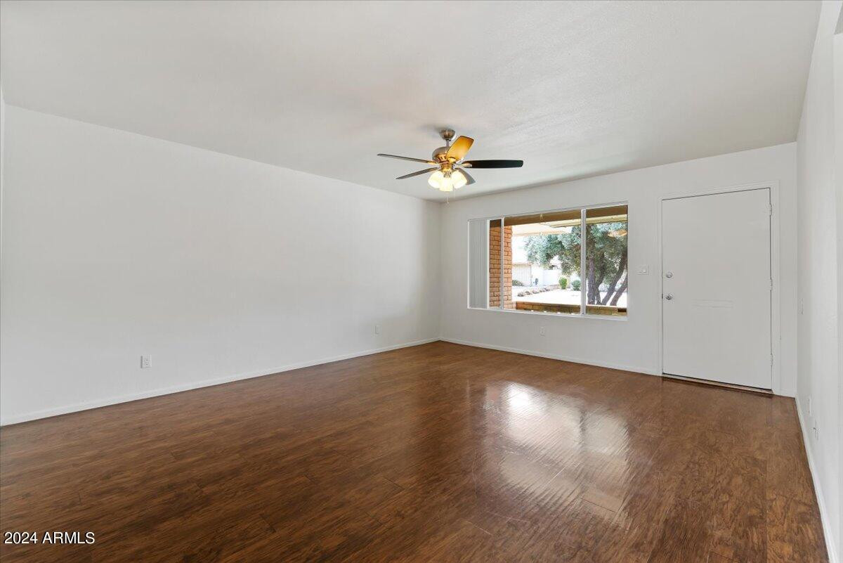 6438 East Butte Street, Unit 2 Mesa, AZ 85205 - Photo 10 of 27 an empty room with wooden floor and windows