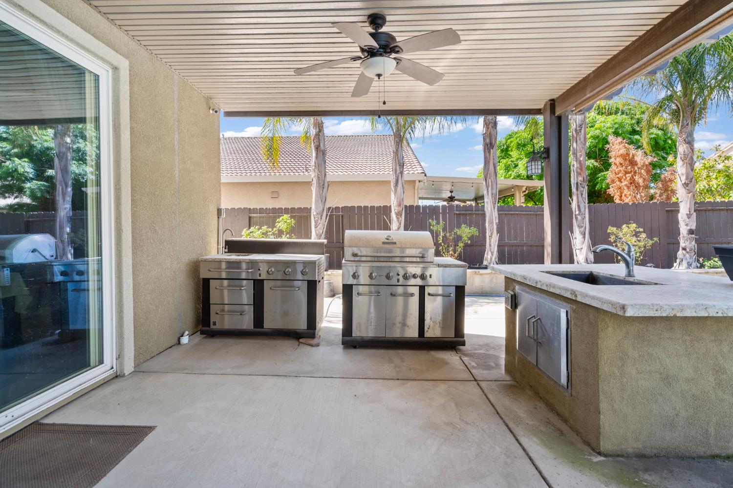 2317 Mathar Drive Manteca, CA 95337 - Photo 42 of 48 a kitchen with stainless steel appliances granite countertop a stove a sink and a refrigerator