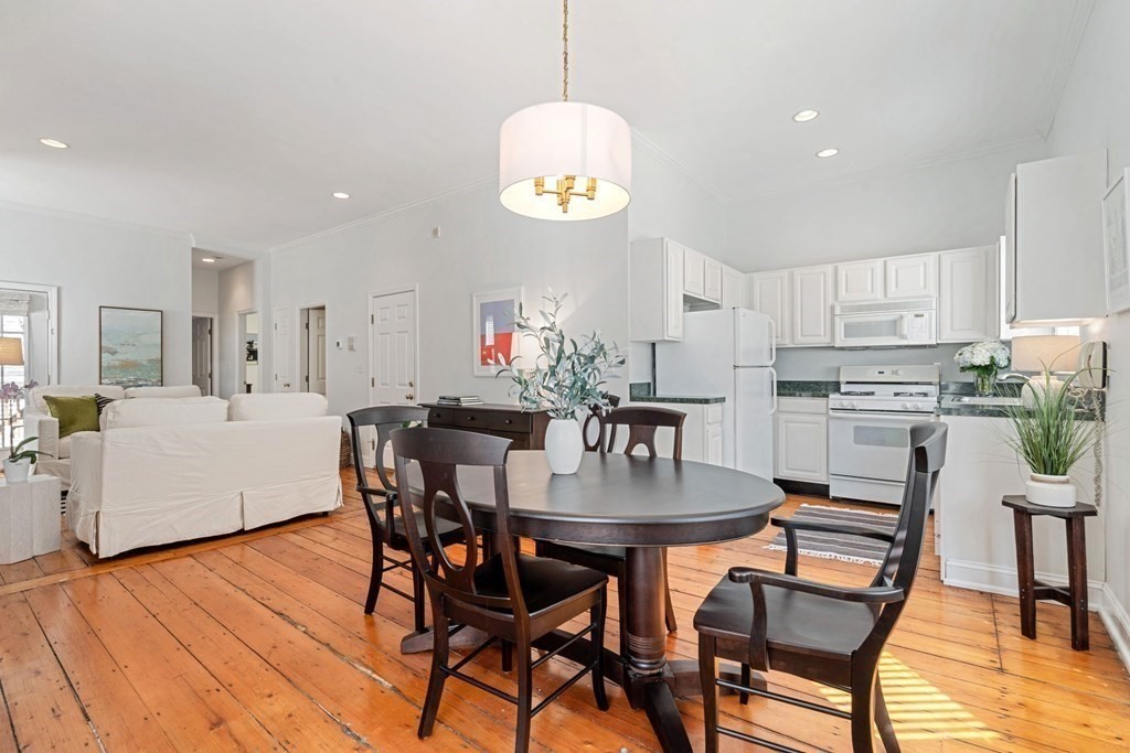 40 Pearl Street, Unit 2 Boston, MA 02129 - Photo 3 of 13 a kitchen with stainless steel appliances a dining table chairs and wooden floor
