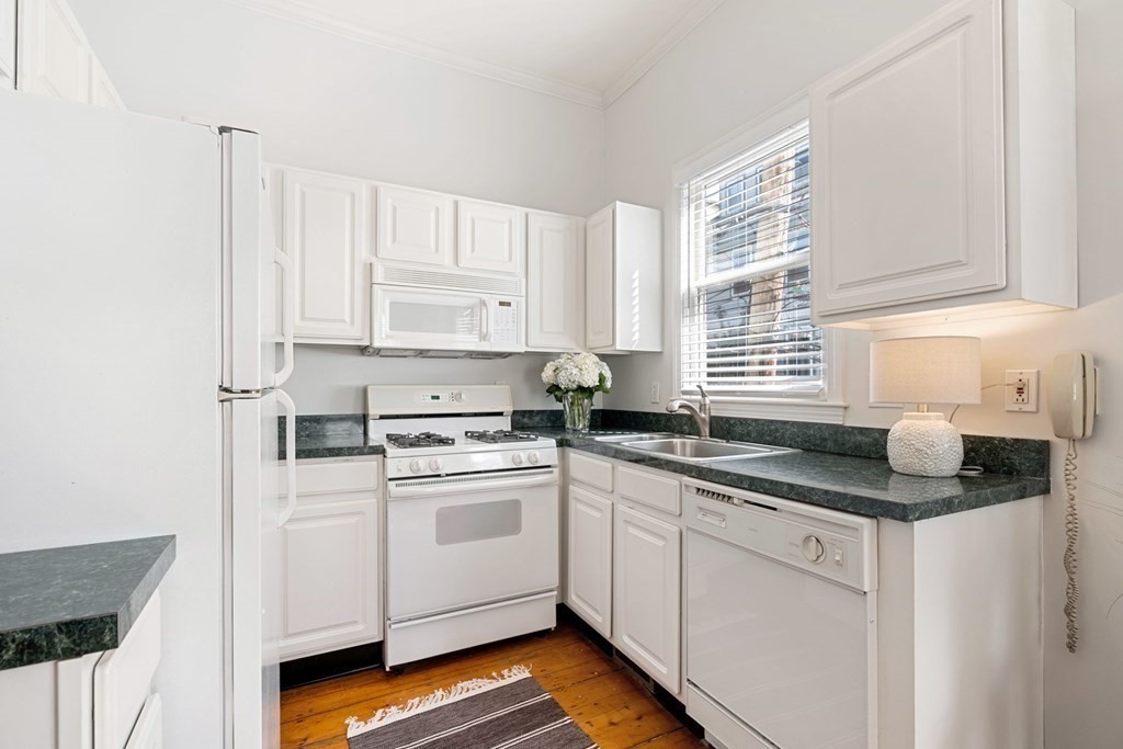 40 Pearl Street, Unit 2 Boston, MA 02129 - Photo 5 of 13 a kitchen with stainless steel appliances granite countertop a sink stove and cabinets