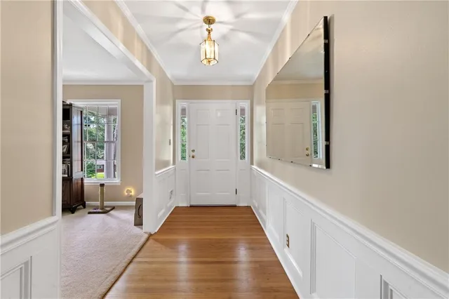 a view of a hallway to a livingroom with furniture