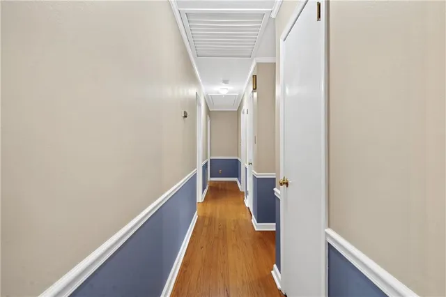 a view of a hallway with wooden floor and staircase