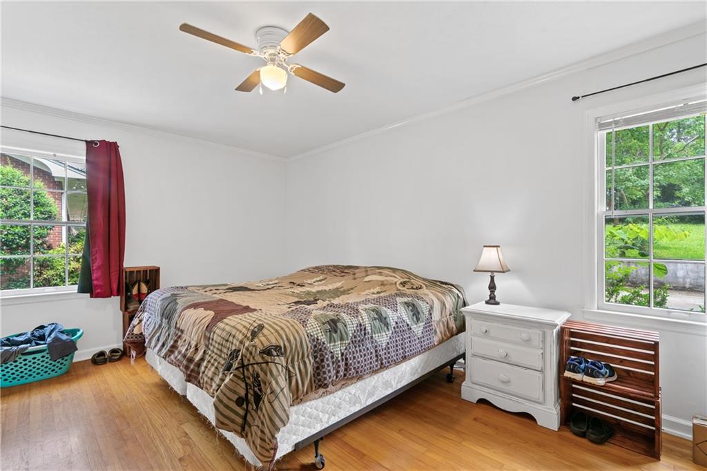 3061 General Lee Road Macon, GA 31204 - Photo 15 of 27 a bedroom with a bed and a chandelier