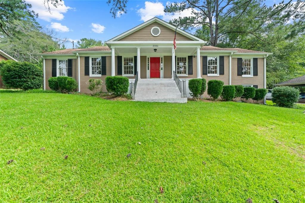3061 General Lee Road Macon, GA 31204 - Photo 27 of 27 a front view of a house with a yard and potted plants