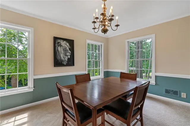 a view of a dining room with furniture window and outside view