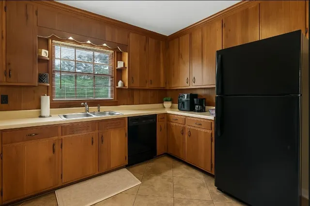a kitchen with a sink stove and refrigerator