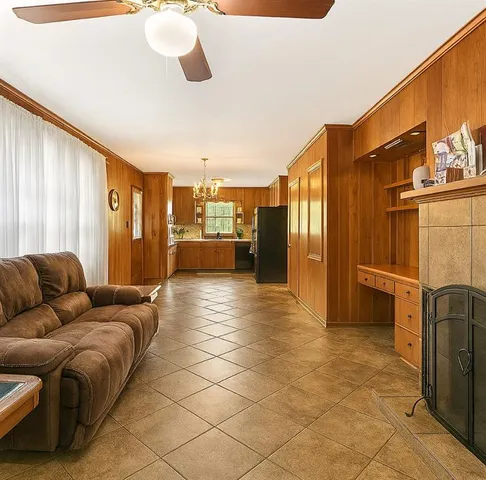 a living room with a couch and a refrigerator
