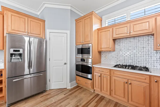 a kitchen with stainless steel appliances a refrigerator and a stove top oven
