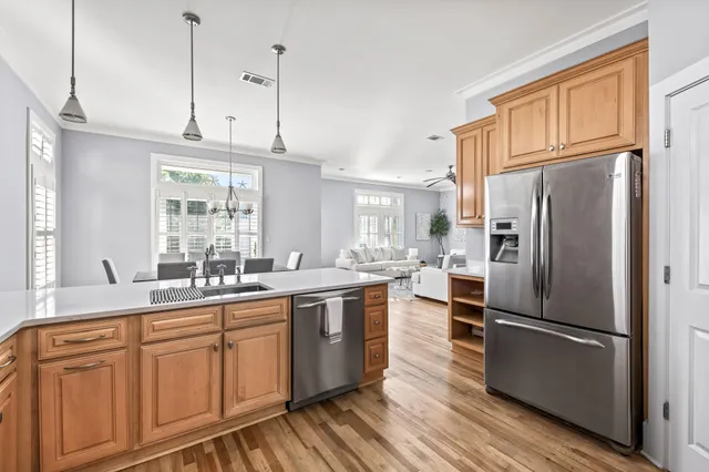 a kitchen with stainless steel appliances a refrigerator sink and cabinets