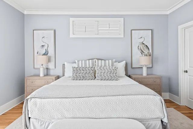 a spacious bedroom with a bed and a flat screen tv