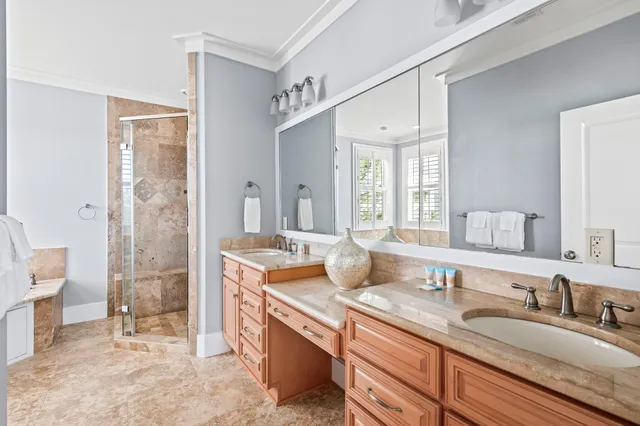 a bathroom with a granite countertop tub a sink and a large mirror