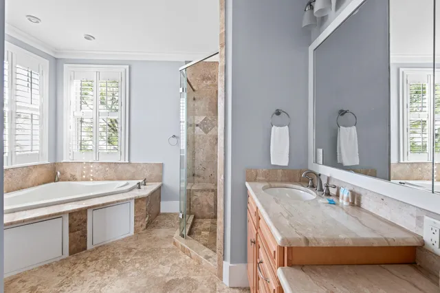 a bathroom with a granite countertop sink and a bathtub