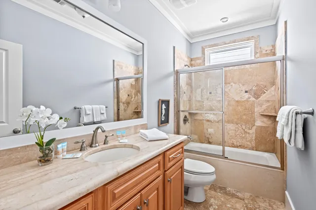 a bathroom with a glass door shower and a sink