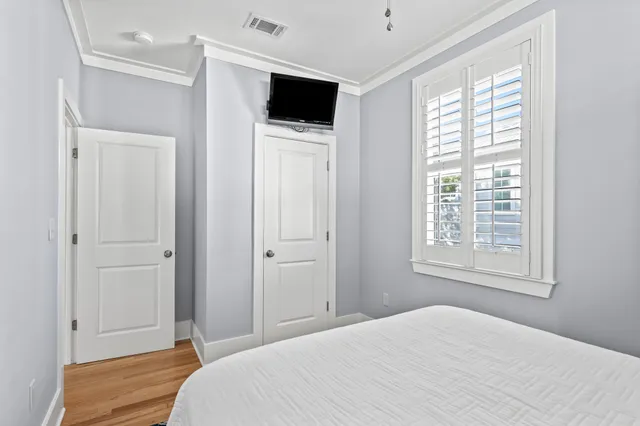 a bedroom with a bed and a flat screen tv