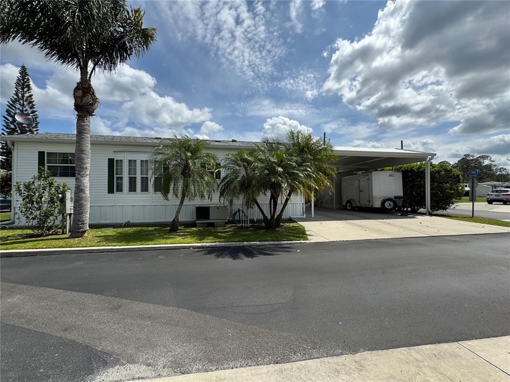 front view of house with a yard and potted plants