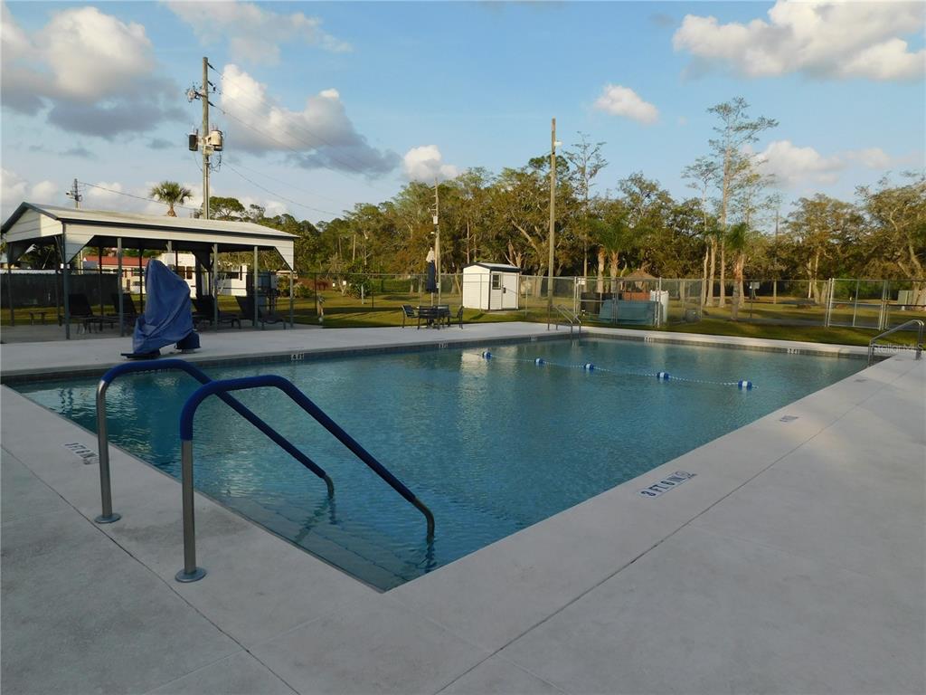 1385 Pine Island Drive St. Cloud, FL 34771 - Photo 25 of 28 a view of a swimming pool with a bench in workspace