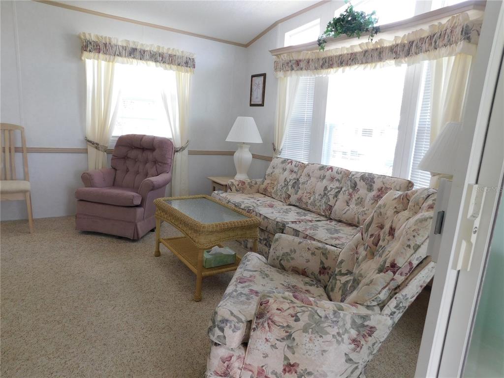 1385 Pine Island Drive St. Cloud, FL 34771 - Photo 5 of 28 a living room with furniture and a large window