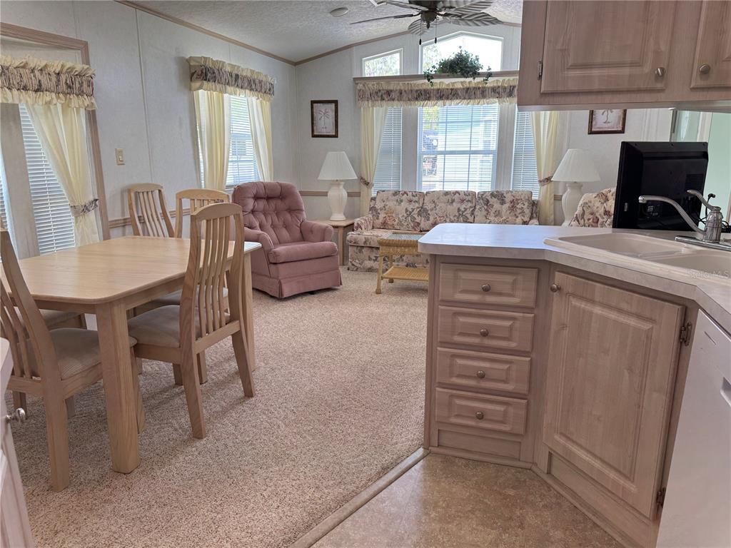 1385 Pine Island Drive St. Cloud, FL 34771 - Photo 6 of 28 a living room with furniture a flat screen tv and a window