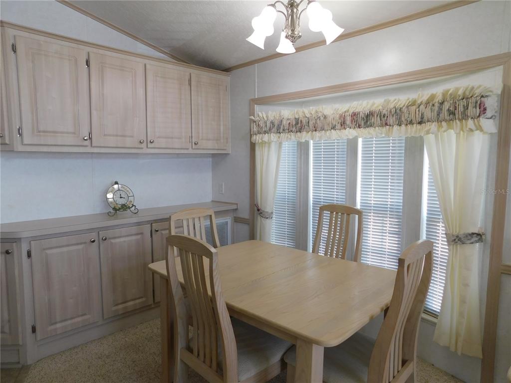 1385 Pine Island Drive St. Cloud, FL 34771 - Photo 7 of 28 a view of a dining room with furniture window and wooden floor