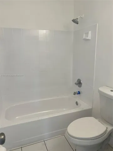 a bathroom with a toilet and a bath tub
