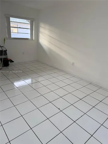 a view of empty room with cabinet