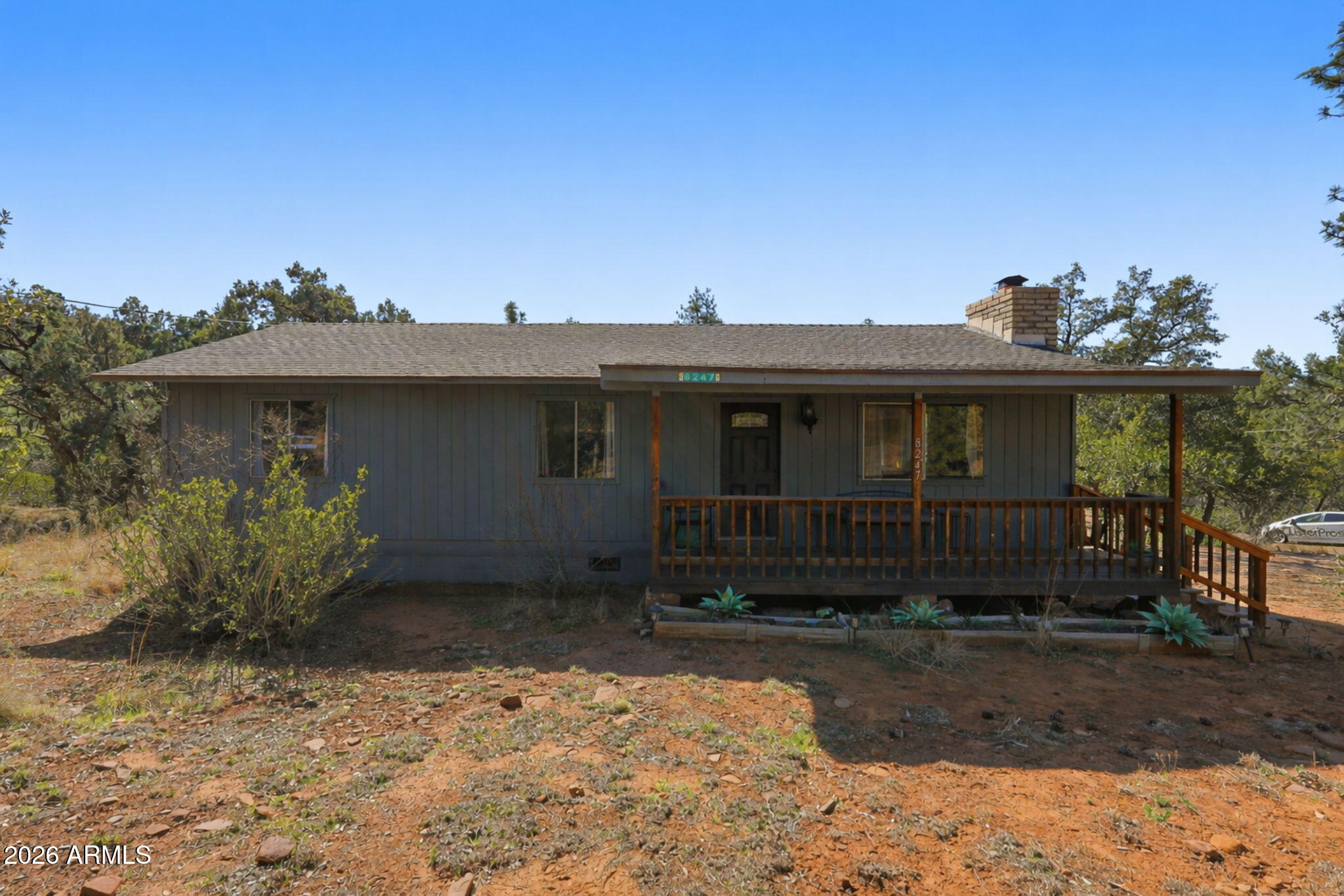 8247 Ralls Drive Pine, AZ 85544 - Photo 49 of 50 a front view of a house with garden