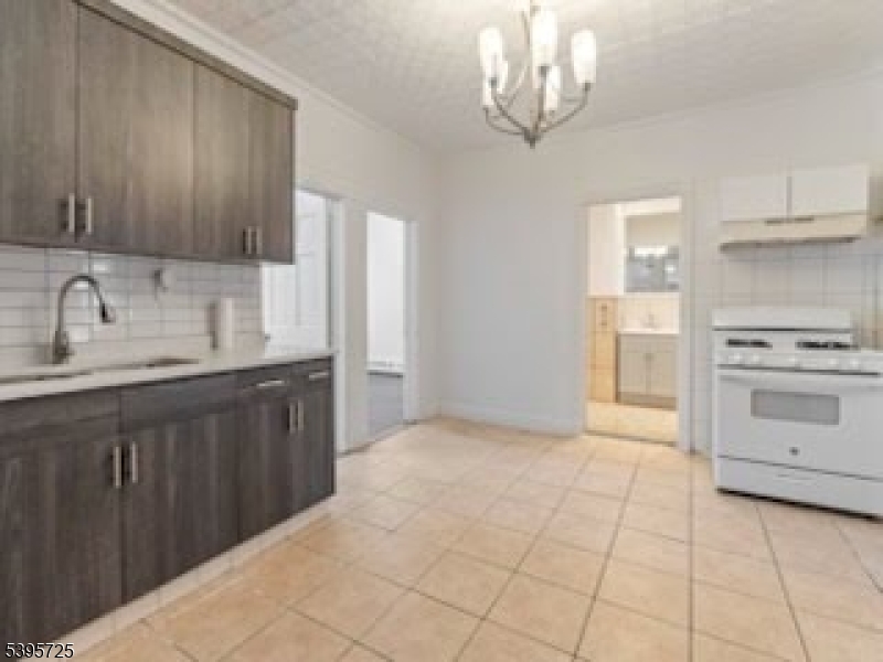 16 Tulip Street Passaic, NJ 07055 - Photo 2 of 7 a kitchen with a sink cabinets and window