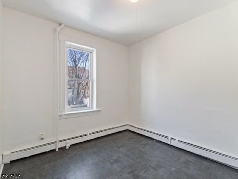16 Tulip Street Passaic, NJ 07055 - Photo 3 of 7 an empty room with a window