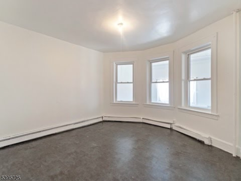 16 Tulip Street Passaic, NJ 07055 - Photo 5 of 7 an empty room with a window