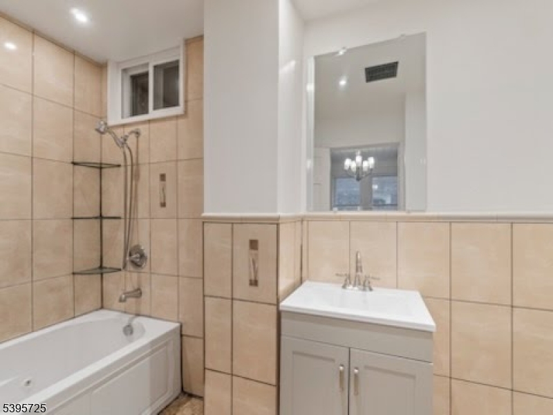 16 Tulip Street Passaic, NJ 07055 - Photo 6 of 7 a bathroom with a bathtub and a sink