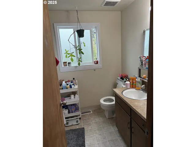 a bathroom with a sink a toilet and a mirror