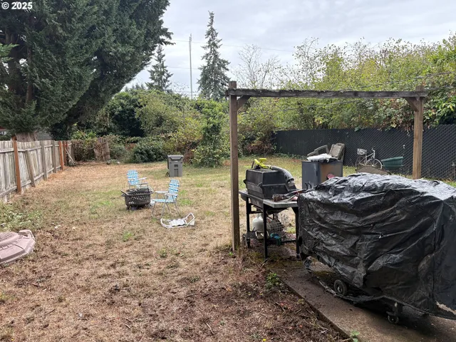 a view of a patio with a table chairs and a floor to ceiling window