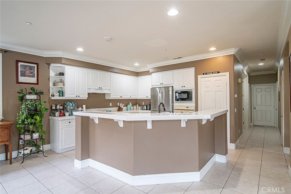22 Via Sonrisa San Clemente, CA 92673 - Photo 16 of 59 a kitchen with stainless steel appliances a table and chairs in it