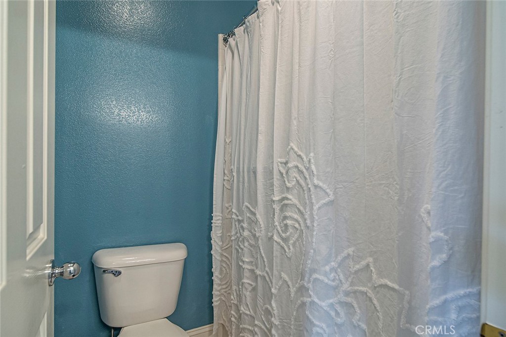 22 Via Sonrisa San Clemente, CA 92673 - Photo 36 of 59 a bathroom with a toilet and a shower curtain