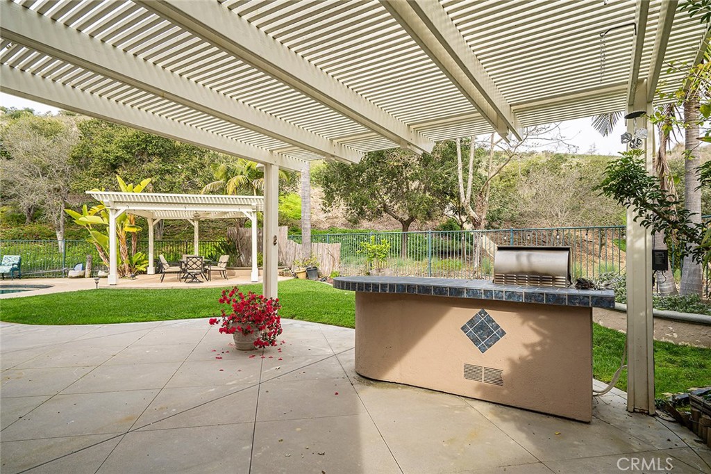 22 Via Sonrisa San Clemente, CA 92673 - Photo 48 of 59 a porch with a table and chairs under an umbrella