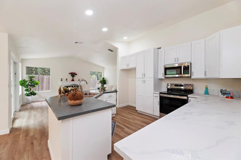 a kitchen with sink a stove and cabinets