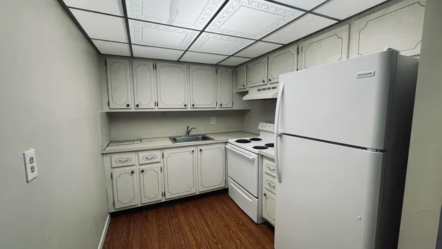 a kitchen with stainless steel appliances a refrigerator sink and cabinets