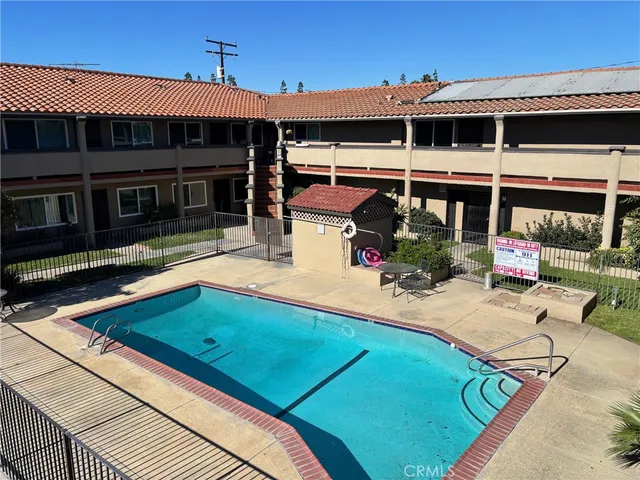a view of a backyard with a patio and fire pit