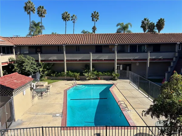 a view of a patio with chairs and plants