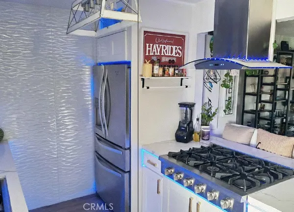 a kitchen with stainless steel appliances granite countertop a stove and cabinets