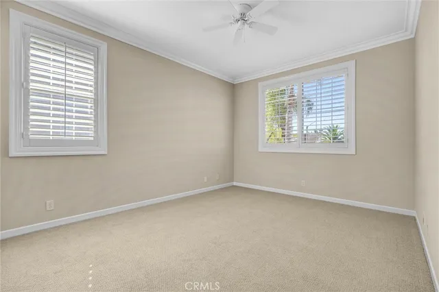 an empty room with cabinet and mirrors