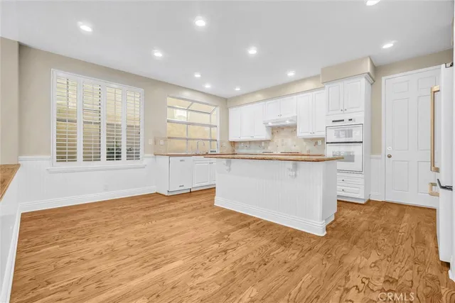 a view of a kitchen with white cabinets