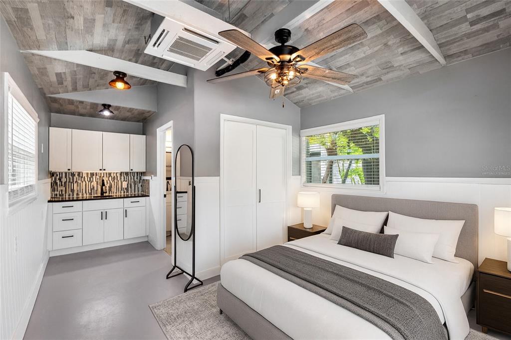 231 East Madeira Avenue Madeira Beach, FL 33708 - Photo 23 of 60 a bedroom with a bed and ceiling fan