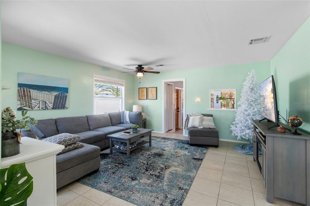 231 East Madeira Avenue Madeira Beach, FL 33708 - Photo 56 of 60 a living room with furniture and a flat screen tv
