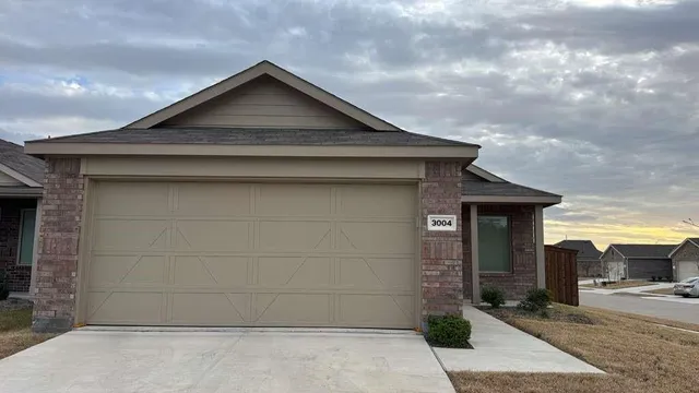 a front view of a house with garage