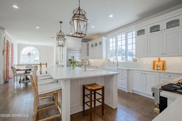 a kitchen with stainless steel appliances granite countertop a sink stove and cabinets