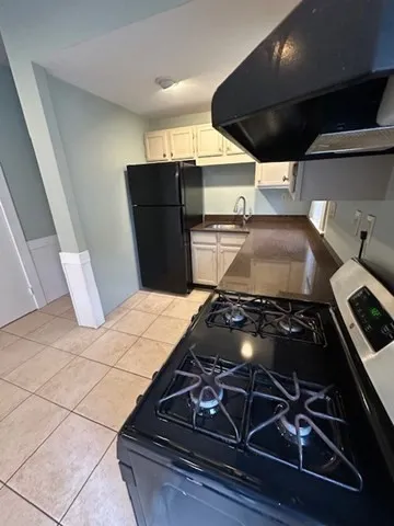 a stove top oven sitting inside of a kitchen